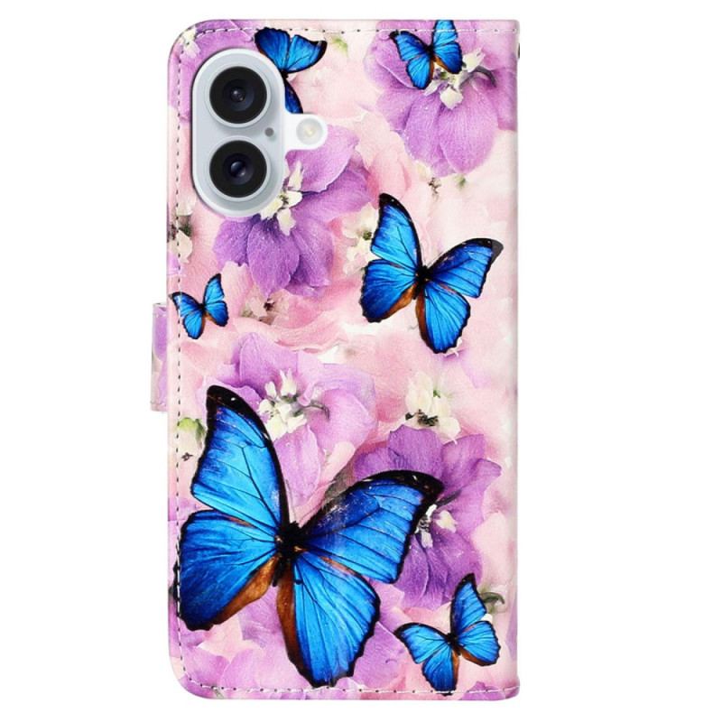 Housse iPhone 16 Papillons Bleus et Fleurs Violettes à Lanière